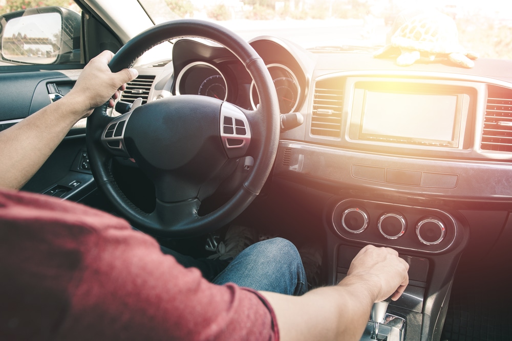 car steering wheel and dashboard, shot over driver's shoulder