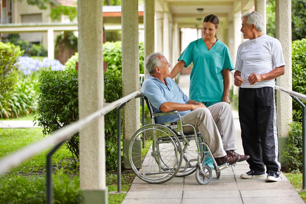 elderly man with nursing home staff member
