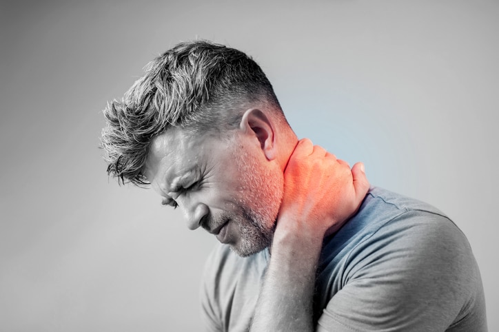 Young man suffering from neck pain.